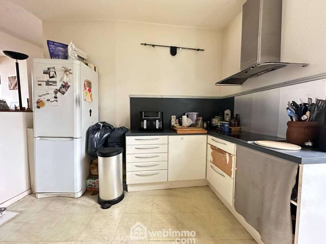 Le séjour est ouvert sur la cuisine de 13 m², elle est aménagée - Appartement à LAON