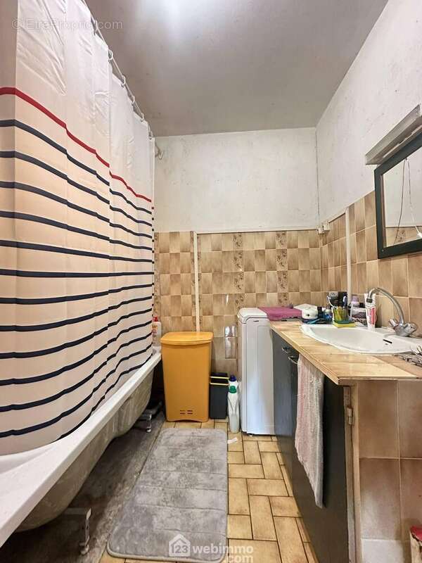 La salle de bains avec vasque sur meuble et une baignoire - Maison à MARTIGNY-COURPIERRE